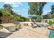 Outdoor kitchen, fire pit, and lush backyard landscaping complete with custom barbeque at 7214 E Royal Palm Rd, Scottsdale, AZ 85258