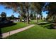 Expansive backyard lawn with brick path leading to stunning pool and outdoor lounge area at 7214 E Royal Palm Rd, Scottsdale, AZ 85258