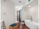 Elegant bathroom featuring a soaking tub, white cabinets, and lots of natural light at 7214 E Royal Palm Rd, Scottsdale, AZ 85258