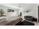 Bright bedroom featuring neutral walls, carpet, ceiling fan, and a work station area by the window at 7214 E Royal Palm Rd, Scottsdale, AZ 85258