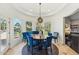 Charming dining area featuring blue accent chairs, a round table, and lots of natural light from the windows at 7214 E Royal Palm Rd, Scottsdale, AZ 85258