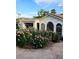 Beautiful home exterior with lush rose bushes and stone driveway at 7214 E Royal Palm Rd, Scottsdale, AZ 85258