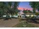 Beautiful home exterior with manicured landscaping and sunset colors at 7214 E Royal Palm Rd, Scottsdale, AZ 85258
