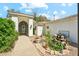 Charming front exterior with a courtyard, manicured landscaping and architectural details at 7214 E Royal Palm Rd, Scottsdale, AZ 85258