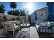 Inviting outdoor patio space with stylish seating, a sunny backyard, and lush greenery at 7214 E Royal Palm Rd, Scottsdale, AZ 85258