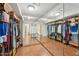 Large walk-in closet with lots of storage space, wood floors, and multiple racks for clothes at 7214 E Royal Palm Rd, Scottsdale, AZ 85258