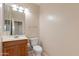 Bathroom featuring a vanity with sink, toilet, and neutral tones at 7421 S 25Th Ln, Phoenix, AZ 85041