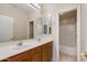 Bathroom featuring double sinks, vanity, and a door to a separate shower and toilet room at 7421 S 25Th Ln, Phoenix, AZ 85041