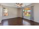 Spacious bedroom features hardwood floors, ceiling fan, and large windows with backyard view at 7421 S 25Th Ln, Phoenix, AZ 85041
