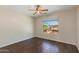 Bedroom with hardwood floors, ceiling fan, and a large window with neighborhood views at 7421 S 25Th Ln, Phoenix, AZ 85041