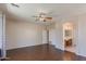Open bedroom floor plan leading into the bathroom with hardwood floors and neutral paint at 7421 S 25Th Ln, Phoenix, AZ 85041