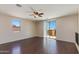 Upstairs bonus room with hardwood floors, ceiling fan, and large sliding glass door at 7421 S 25Th Ln, Phoenix, AZ 85041