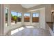 Bright breakfast nook features tile flooring, multiple windows, and backyard views at 7421 S 25Th Ln, Phoenix, AZ 85041
