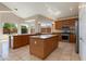 Gourmet kitchen features granite countertops, a center island, and tile flooring at 7421 S 25Th Ln, Phoenix, AZ 85041