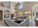 Bright open living room with fireplace, modern decor, tall windows, and high vaulted ceilings at 7421 S 25Th Ln, Phoenix, AZ 85041
