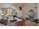 Bright living room featuring high ceilings, large arched windows, and modern decor at 7421 S 25Th Ln, Phoenix, AZ 85041