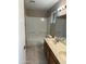 Bathroom featuring a wood vanity with a double sink and a shower-tub combo at 8117 W Dreyfus Dr, Peoria, AZ 85381