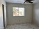 Bedroom with tile flooring, neutral paint, and a window dressed with blinds at 8117 W Dreyfus Dr, Peoria, AZ 85381