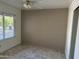 Bedroom with tile flooring, neutral paint, a window, and ample closet space at 8117 W Dreyfus Dr, Peoria, AZ 85381
