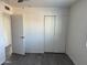 A bright and airy bedroom featuring modern floors and a spacious closet, ready for your personal touch at 8117 W Dreyfus Dr, Peoria, AZ 85381