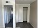 Bedroom with gray laminate floors, closet, and neutral walls at 8117 W Dreyfus Dr, Peoria, AZ 85381