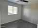 Cozy bedroom with wood-look flooring and a bright window, creating a serene and inviting atmosphere at 8117 W Dreyfus Dr, Peoria, AZ 85381