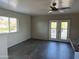 Bright living area featuring wood-look flooring, a ceiling fan, and access to the outdoors at 8117 W Dreyfus Dr, Peoria, AZ 85381