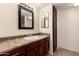 Bathroom featuring a well-lit vanity with dark wood cabinets and a light, speckled countertop at 8301 N 21St Dr # F102, Phoenix, AZ 85021