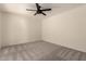 Bright bedroom with neutral carpet, ceiling fan, and natural light at 8301 N 21St Dr # F102, Phoenix, AZ 85021