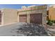 Exterior view of attached garages with doors and asphalt driveway at 8301 N 21St Dr # F102, Phoenix, AZ 85021