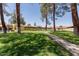 Community green area with walking path and mature trees at 8301 N 21St Dr # F102, Phoenix, AZ 85021