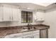 Kitchen with stainless steel sink, granite countertops, and white cabinets at 8301 N 21St Dr # F102, Phoenix, AZ 85021