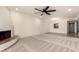 Spacious living room with fireplace and modern ceiling fan flows into dining area at 8301 N 21St Dr # F102, Phoenix, AZ 85021