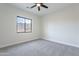 Naturally lit bedroom featuring a ceiling fan and mountain views at 9626 E Bunny Ear E Ln, Gold Canyon, AZ 85118