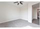 A clean, empty bedroom showcases a ceiling fan and a bathroom at 9626 E Bunny Ear E Ln, Gold Canyon, AZ 85118