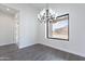 Minimalist dining room with modern chandelier and large window, offering scenic desert views at 9626 E Bunny Ear E Ln, Gold Canyon, AZ 85118