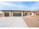 Beautiful single-story home featuring a stone facade, desert landscaping, and a spacious three-car garage at 9626 E Bunny Ear E Ln, Gold Canyon, AZ 85118
