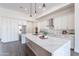 Bright kitchen with waterfall island, white cabinets and stainless steel appliances at 9626 E Bunny Ear E Ln, Gold Canyon, AZ 85118