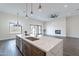 Modern kitchen boasts a waterfall island, stainless steel appliances, and an open layout into the living area at 9626 E Bunny Ear E Ln, Gold Canyon, AZ 85118