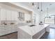 Bright kitchen featuring a waterfall island, stainless steel appliances, and modern lighting fixtures at 9626 E Bunny Ear E Ln, Gold Canyon, AZ 85118