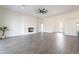 Bright living room with a modern fireplace, ceiling fan and views through the entryway at 9626 E Bunny Ear E Ln, Gold Canyon, AZ 85118