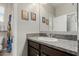 Bathroom featuring a granite countertop and dark wood cabinets at 9747 W Sands Dr, Peoria, AZ 85383