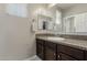 Bathroom with vanity, granite countertop, and a framed mirror at 9747 W Sands Dr, Peoria, AZ 85383