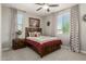Bedroom with decorative curtains, ceiling fan and comfortable carpet at 9747 W Sands Dr, Peoria, AZ 85383