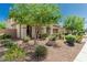Single-Gathering home with desert landscaping and a covered porch entryway at 9747 W Sands Dr, Peoria, AZ 85383