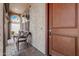 Inviting covered front porch with seating and a stylish front door at 9747 W Sands Dr, Peoria, AZ 85383