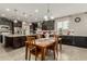 Kitchen and dining area with dark cabinets, granite countertops, stainless appliances, and pendant lighting at 9747 W Sands Dr, Peoria, AZ 85383