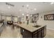 Kitchen island with granite countertop and sink in an open-concept layout with sightlines to the Gathering room at 9747 W Sands Dr, Peoria, AZ 85383