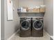 Enjoy convenience with a modern washer and dryer set in this organized laundry room at 9747 W Sands Dr, Peoria, AZ 85383