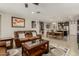 Spacious living room flowing into the dining area, featuring comfortable leather seating at 9747 W Sands Dr, Peoria, AZ 85383